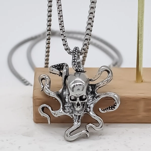 Retro Cthulhu octopus skull pendant necklace with silver finish on minimalist stand