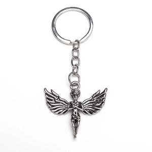 Silver vintage angel pendant keychain with detailed wings on white background