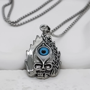 Vintage punk skull pendant with blue evil eye and silver flame texture on stone