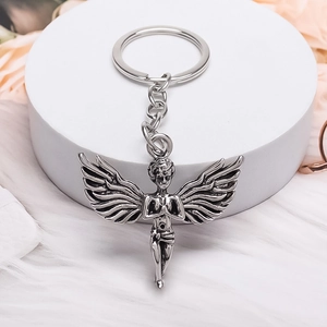 Polished silver alloy angel keychain with wings and prayer design on white pedestal