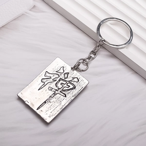 Retro zen square metal keychain with embossed Chinese character on white plush background