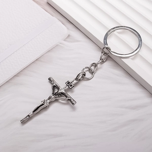 Vintage silver alloy cross pendant keychain with detailed religious embossed design