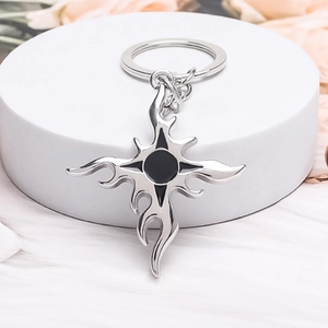 Detailed macro view of the vintage flame cross silver alloy keychain with black inlay details