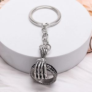 Gothic skull hand holding circle keychain in retro silver finish for punk street style
