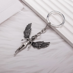 Vintage silver angel pendant keychain with detailed wing texture on a clean white background