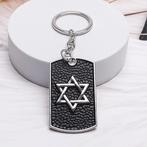 Hip hop hexagram dog tag keychain with silver star of David on black textured background