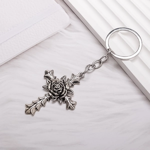 Gothic rose cross keychain in antique silver finish on a soft white background