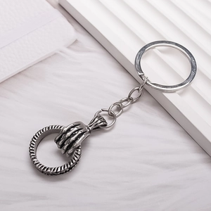 Retro silver skeleton hand keychain with textured metal ring in punk rock gothic style