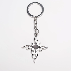 Vintage flame cross keychain with black accents and metallic silver star pendant detail
