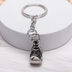 Minimalist alloy boxing glove keychain with vintage silver finish and realistic stitching