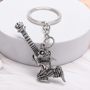 Retro punk keychain with skull guitar and claw pendant in antique silver finish
