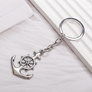 Minimalist silver anchor and helm keychain with vintage metallic finish on a white background