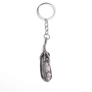 Detailed retro silver feather pendant featuring intricate eagle claw and bird stamp design