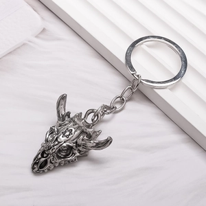 Vintage alloy bull skull keychain with star detail and antique silver finish on white background