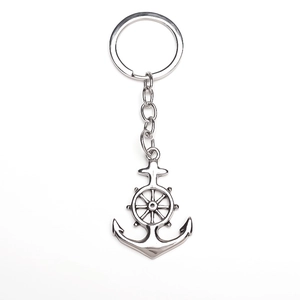 Detailed view of silver alloy nautical keychain with anchor and helm charm on white background