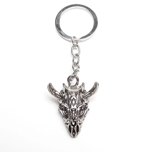 Macro shot of punk style bull skull keychain with intricate engraved hexagram symbol