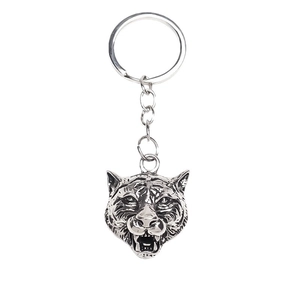 Antique silver tiger head keychain with geometric ring and chain on white background