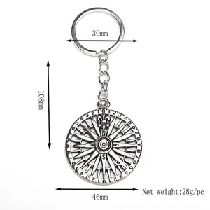 Silver metal compass keychain with nautical wheel design and dimension markings