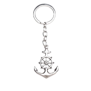 Silver nautical keychain with anchor and ship wheel charms on a minimalist metal ring