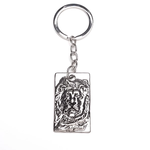 Detailed relief of a majestic lion head on a silver rectangular metal keychain charm
