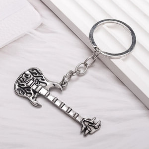 Retro rock style electric guitar keychain with flame texture on white plush background