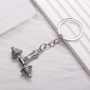 Vintage silver fitness keychain featuring a barbell fist pendant on a white background