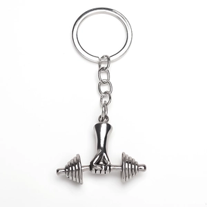 Detailed view of silver gym keychain featuring a fist clenching a dumbbell