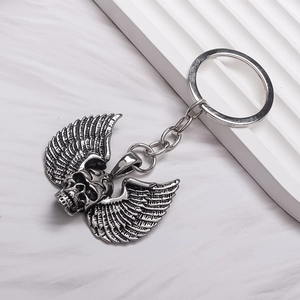 Retro punk skull and wing metal keychain accessory with vintage dark design detail