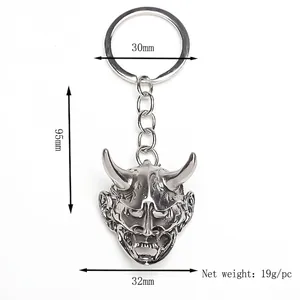 Silver metal Hannya mask keychain with engraved details and 30mm ring for bag charm