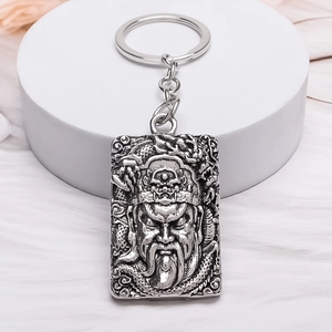 Vintage silver alloy keychain featuring Guan Yu warrior and dragon relief carving
