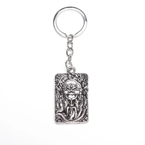 Detailed antique silver keychain featuring a traditional Chinese warrior relief and dragon