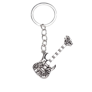 Creative silver electric guitar keychain with detailed flame pattern engraving on white background