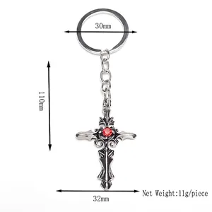 Retro punk gothic cross keychain with a red gemstone in a silver finish and hollow design