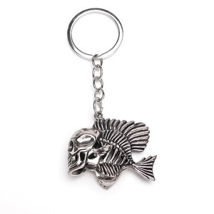 Detailed view of punk style gothic keychain with antique silver skull fish bone design