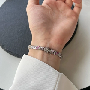 Elegant S925 silver bracelet featuring pink and clear zircon gemstones on female wrist
