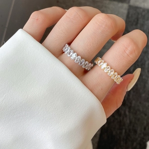Detail of S925 silver eternity bands with oval-cut cubic zirconia in gold and silver finish