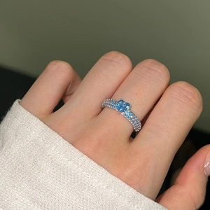 Close-up of S925 silver ring featuring a blue heart-shaped zircon and micro-pave setting