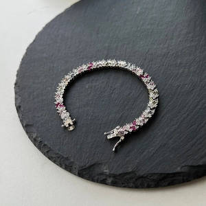Elegant S925 sterling silver tennis bracelet with colorful zircon stones on a black stone base