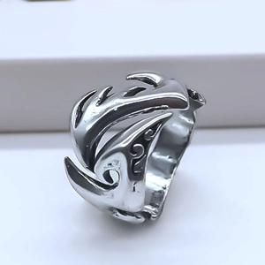 Detail of silver flame pattern ring with vintage punk style and adjustable open band