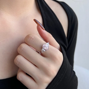 Macro shot of a S925 silver ring featuring a pink emerald-cut gemstone and side diamonds