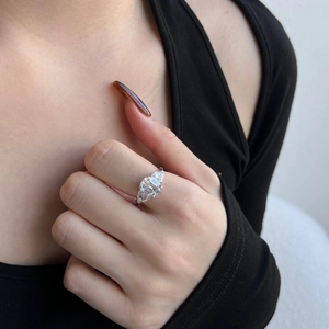 Detailed view of an S925 silver ring featuring emerald cut zircon with side diamonds