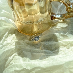 Detailed close-up of a S925 sterling silver ring with a large round diamond-cut stone