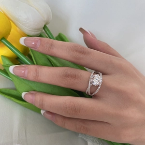 Classic S925 silver ring on model hand with round solitaire diamond and intertwined bands