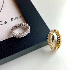 Macro detail of oval cut zircon eternity rings in silver and gold plating