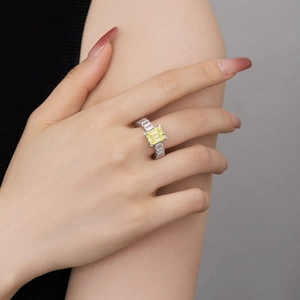 Detail of a luxury S925 silver ring featuring a large yellow rectangle zircon on a finger