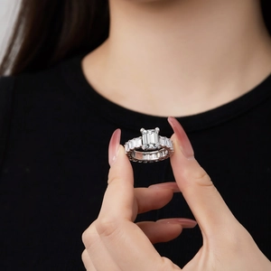 Macro detail of an emerald cut zirconia ring with baguette side stones on a S925 band