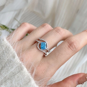 S925 silver ring with rectangular blue zircon and interwoven micro-pave cubic zirconia bands