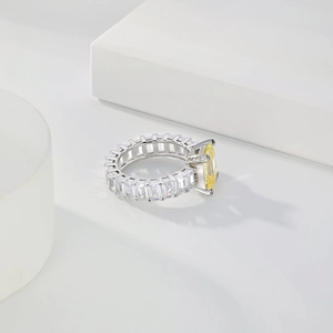 Macro shot of S925 silver wedding ring with emerald-cut yellow zircon and side stones