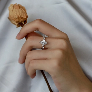 Macro-opname van een ring met marquise-zirkonia op een zachte witte satijnen basis