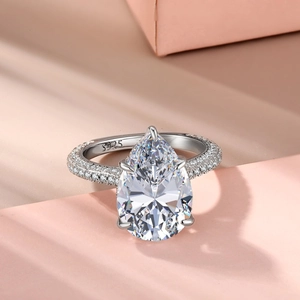 Detail of S925 hallmark on a silver pear cut diamond ring with pave diamond setting